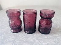 Three amethyst purple Wheaton jars side by side