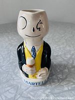 Front view of Mr. Brandyman jug showing face, torso and MARTELL text on base