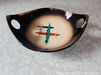 Top view of copper lustre bowl showing abstract interior design and both handles