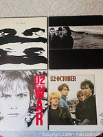 Group shot of all four U2 album covers: Boy, The Joshua Tree, War, October