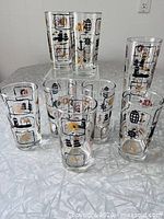 Full set of eight tumblers showing variety of nautical graphics