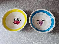 Radish and grape motif bowls side by side