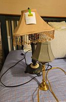 Both lamps side by side on bed showing full view