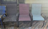 Front view of three mesh patio chairs showing colors and condition