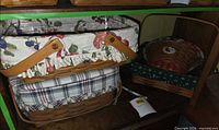 Shelf view showing rectangular fruit-print basket stacked with plaid-liner basket and round lidded basket in green caddy