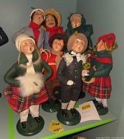 Group of seven Byers Choice Caroler figures on shelf