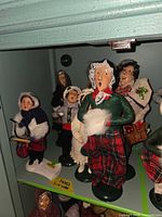 Group of Byers' Choice caroler figures on shelf