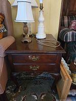 Front view of American Drew two-drawer end table showing brass pulls and cabriole legs