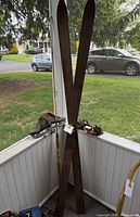 Overall lot showing wooden skis, fishing rod, skates