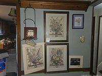 Overall wall view showing framed prints, unframed prints and plaque hanger
