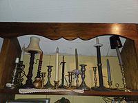 Shelf view showing full assortment of candlesticks in various materials and heights