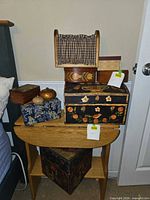 Stack of assorted decorative boxes on wooden stand showing variety and sizes