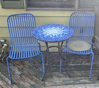 full view of table and two chairs on deck