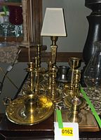 Group shot showing all brass candlesticks