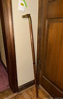 Full view of cane leaned against wall