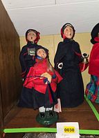 Three Byers' Choice Salvation Army figures on shelf