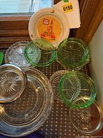 Group of ashtrays showing Disney ceramic, three green uranium and clear glass pieces