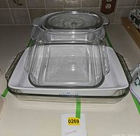Stacked view showing Pyrex square and rectangular bakers atop ceramic pieces