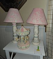 Pair of lamps with carousel on white table