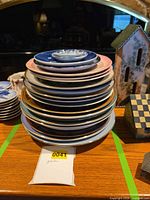 Stack of various decorative plates in multiple colours and sizes