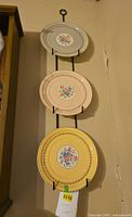 Full view of three plates on wall hanger