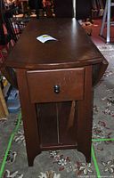 Side view of table with leaves down showing drawer and shelf