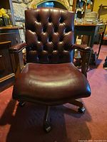 Front view showing tufted leather back, arms, seat