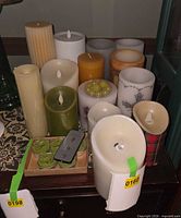 Group view of assorted flameless candles on tabletop