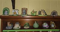 Shelf view showing seven Woodland Surprises figurines top row
