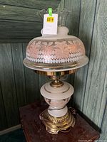 Full view of lamp showing globe, chimney, and brass base