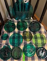 All 14 green pressed glass pieces laid out to show quantity and variety
