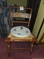 Front view of Hitchcock chair with placemats on seat