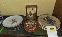 Stack of six flat Hummel plates, two relief plates, round music box, rectangular music box