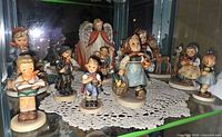 Shelf view showing multiple Goebel Hummel figurines