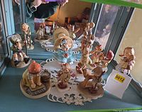 All eight figurines displayed inside cabinet