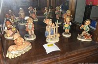 Cabinet shelf with the grouped Hummel figurines