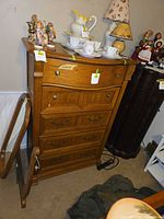 Front view of oak dresser showing drawers and hardware