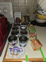 Overview of egg coddlers, metal lids visible