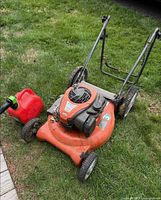 Top and side view of orange Husqvarna lawn mower with red fuel can