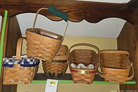 Shelf showing five Longaberger baskets of various sizes, liners visible