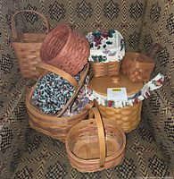 Group shot of all 8 Longaberger baskets arranged on patterned chair