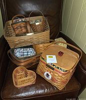 Group shot of all visible Longaberger baskets on chair showing variety and quantity