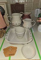 All items grouped showing pitchers, baking dish, tumbler, bowls, trivet