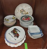 Group of assorted miniature plates and dishes on shelf