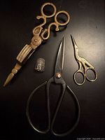 Group shot of three scissors and sterling thimble
