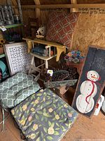 Overall view showing cushions, divider, snowman sign, lanterns, planter with pinecones