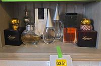 Front view of entire shelf showing all eight perfume bottles