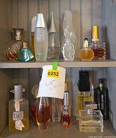 Two shelves with assorted perfume bottles
