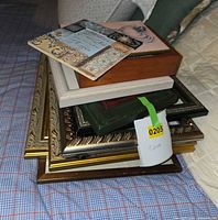 Stack of various small framed pieces