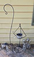 Group view of shepherd’s hook, tripod planter stand, tricycle solar stands